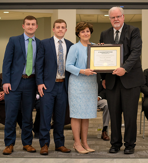 The DePerros receive the honorary degree from Dr. Joe Zimmer, acting president