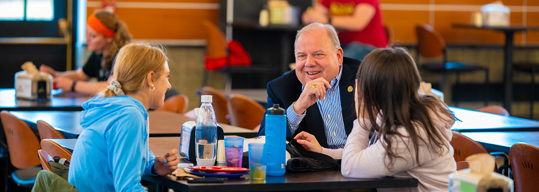 Dr. DePerro in Hickey Dining Hall with students