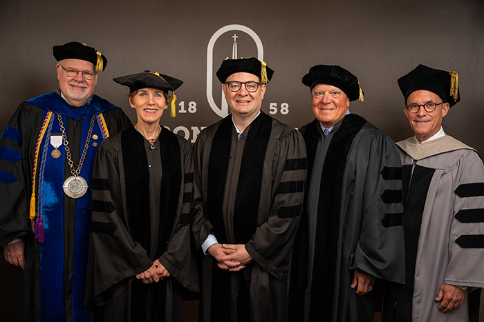 Honorary degree recipients Maureen Keenan LeBoeuf, Adrian Wojnarowski and Tom Marra are flanked by President Joe Zimmer (left) and Trustees Chair John Sheehan.