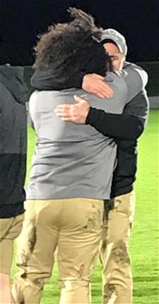 Bonnies coaches Osborne and Neighbour hug after the game