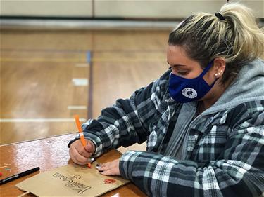 Jess Helmbrecht decorates an activity bag for her Buddy. 