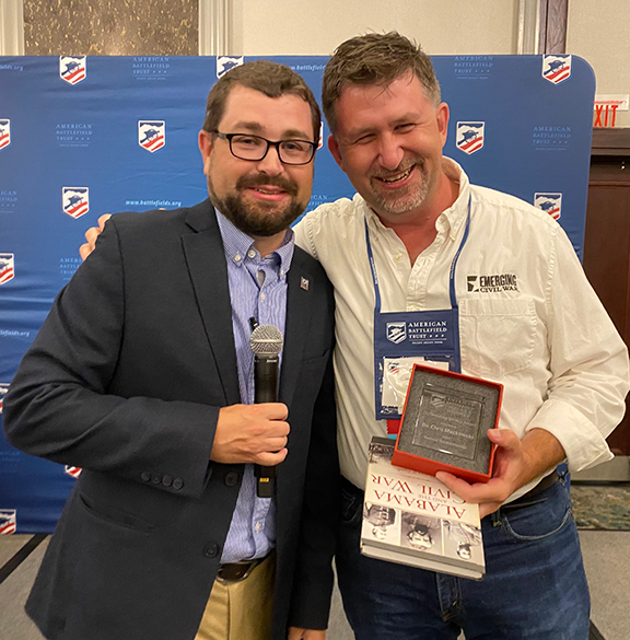 Chris Mackowski (right) accepts an award for outstanding service from the American Battlefield Trust from the trust’s Deputy Director of Education Kristopher D. White at a July 23 event in Mobile, Alabama.