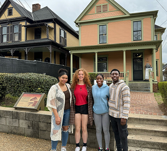 Aaliyah Foskolos (from left), Luka Galle, Sanayia Joefield and Michael Assim stand in front of Martin Luther King Jr.’s Atlanta birth home (on left), which is under restoration until 2025.