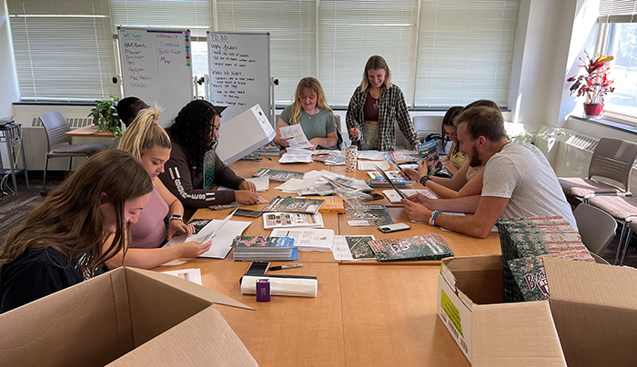Orientation leaders pack folders for incoming students Orientation leaders pack folders for incoming students