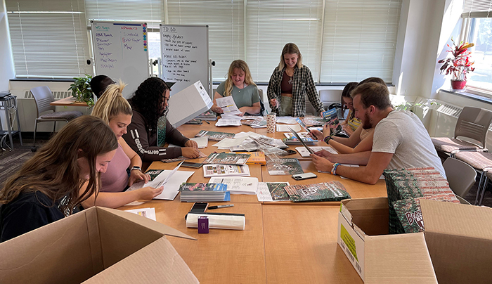 Orientation leaders pack folders for incoming students