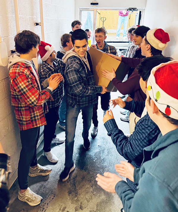 Boys from St. Joe's deliver the last box of their food donation to the Warming House.