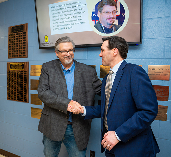 Dean Aaron Chimbel (right) shakes Vaccaro's hand after the unveiling of the plaque