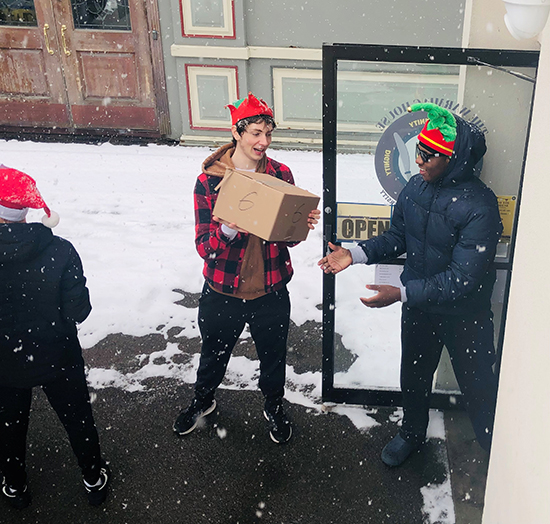 Students unload the truck at the Warming House
