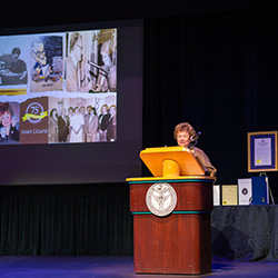 Joan Licursi, Class of 1965, at the podium.